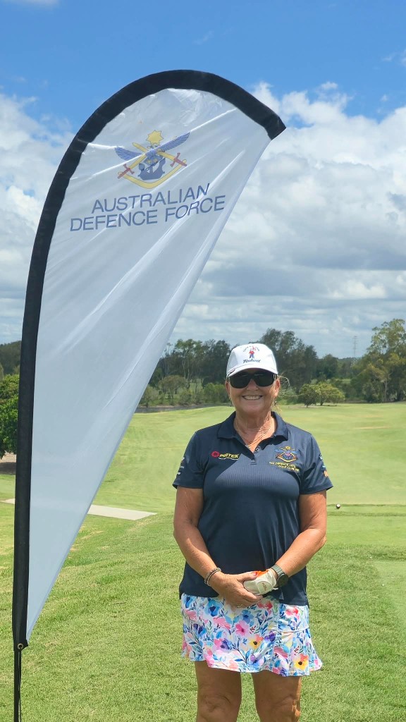 Member with the Australian Defence Force flag on the course